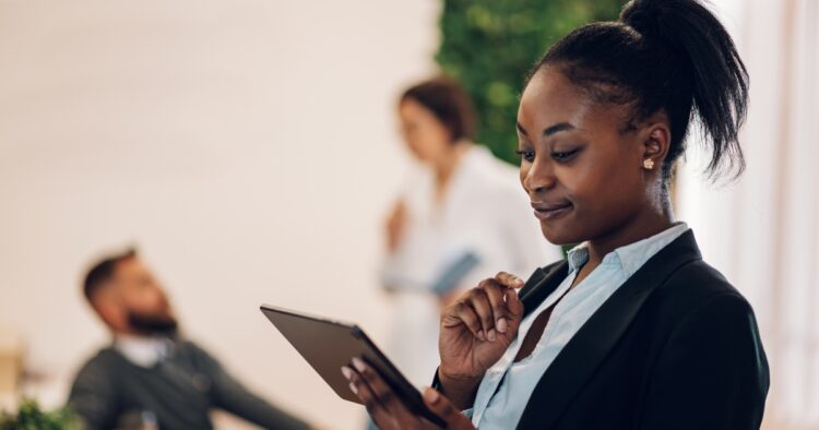 An ambitious sales professional taking initiative in a modern office, representing an employee-preneur mindset.