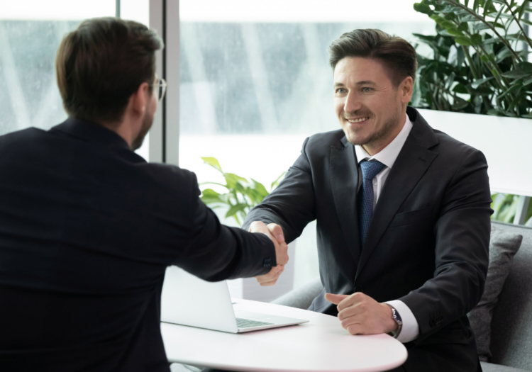 Two people in an office shaking hands