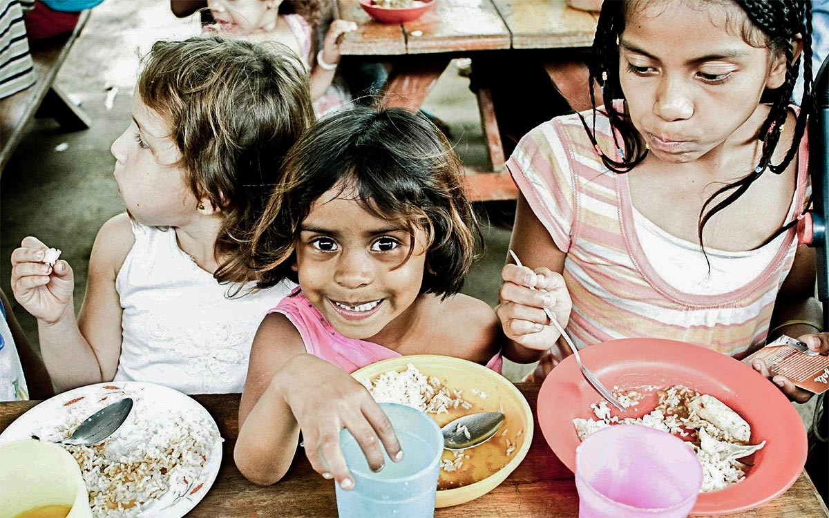 Citrus Connects corporate social responsibility cause - Orphans eating and drinking at a table
