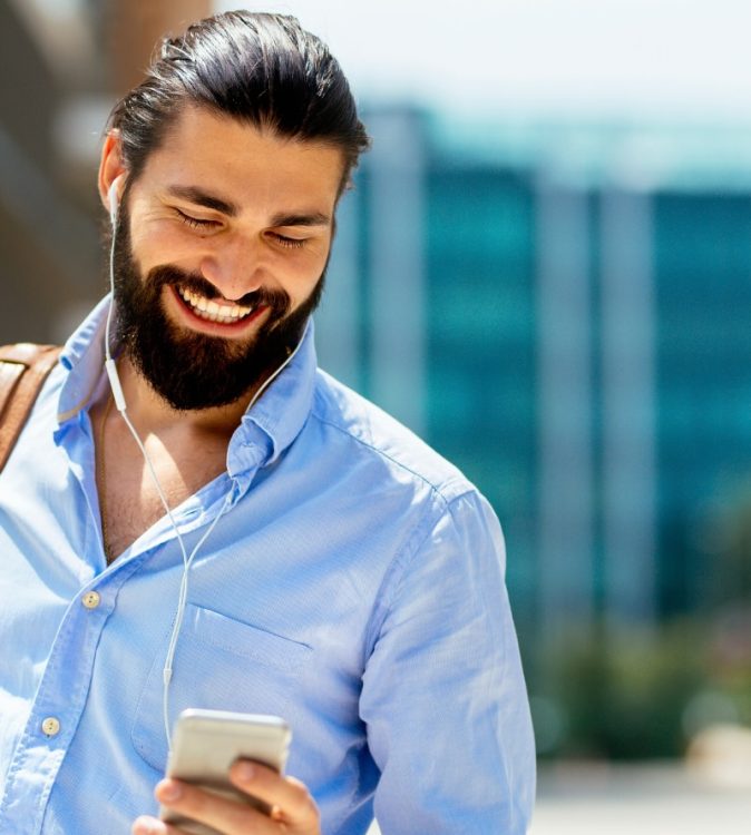A professional smiling while checking career updates on a smartphone, illustrating navigating UK job market trends.