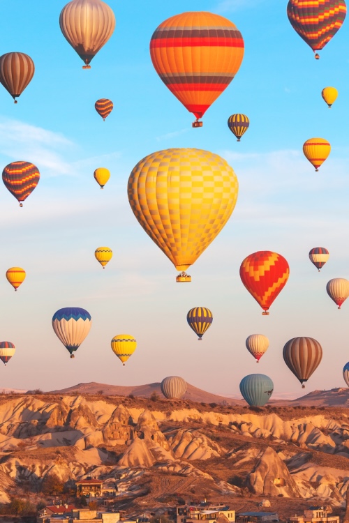 Multiple hot air balloons rising over a landscape, illustrating career growth and ambition when moving from telesales to field sales.