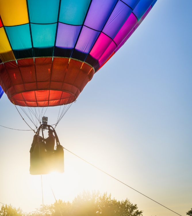 A colourful hot air balloon ascending into the sky, representing an ambitious career transition from telesales to field sales.