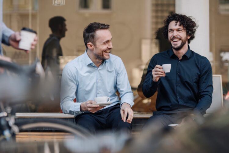 Two sales professionals discussing how to hire self-employed sales reps for business growth.