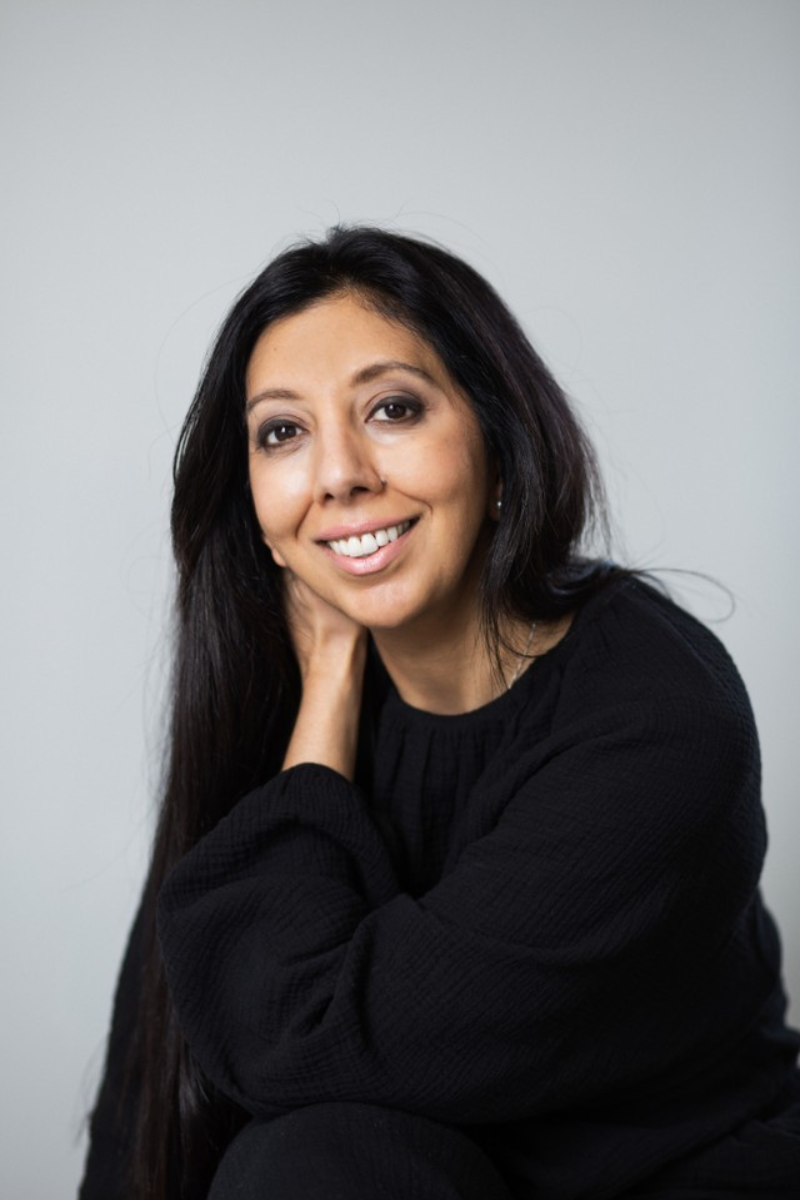 Leena Parmar, CEO smiling at the camera