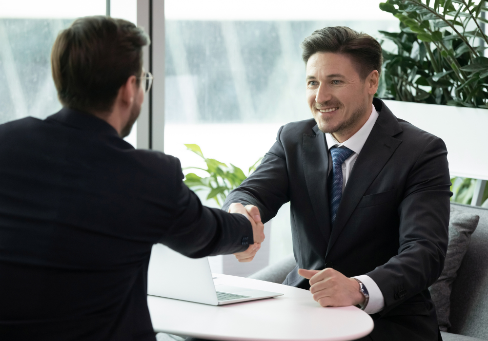 Two people in an office shaking hands