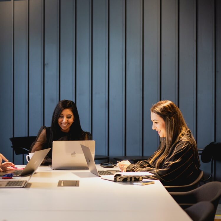 Citrus Connect Recruitment team working on a table with laptops smiling