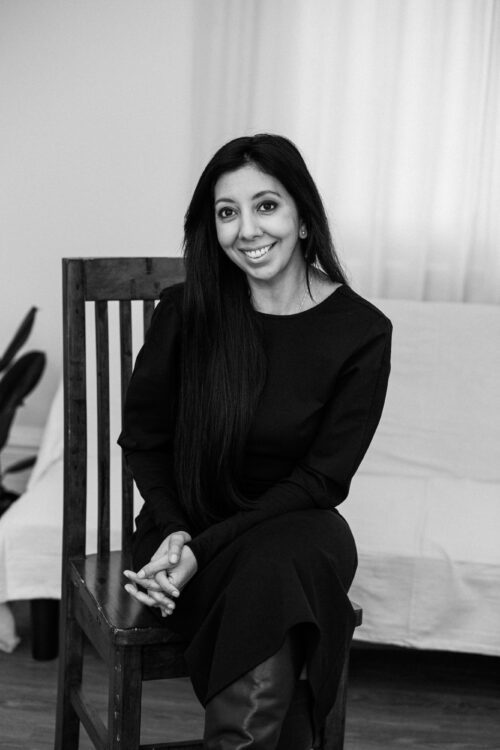 Leena Parmar sat in a chair in black and white