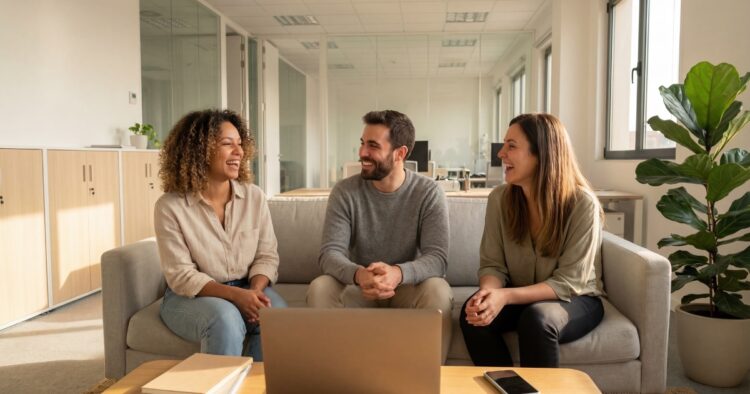 A diverse and engaged business team collaborating in a modern office, representing a strong workplace culture.