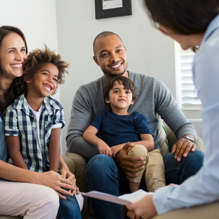 A consultative B2C sales professional speaking with a family in their home.