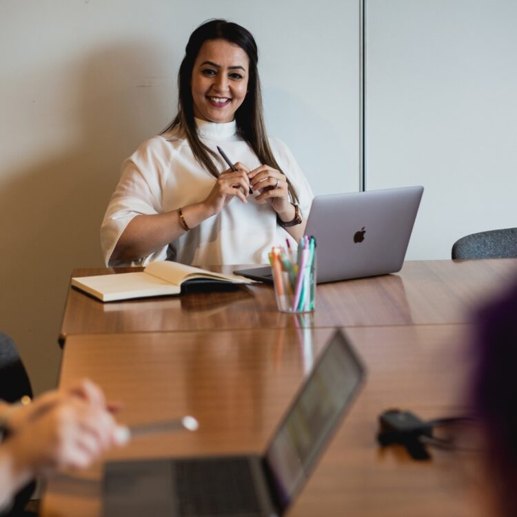 Rumina, Head of Recruitment at Citrus Connect, smiling during a collaborative team strategy meeting.