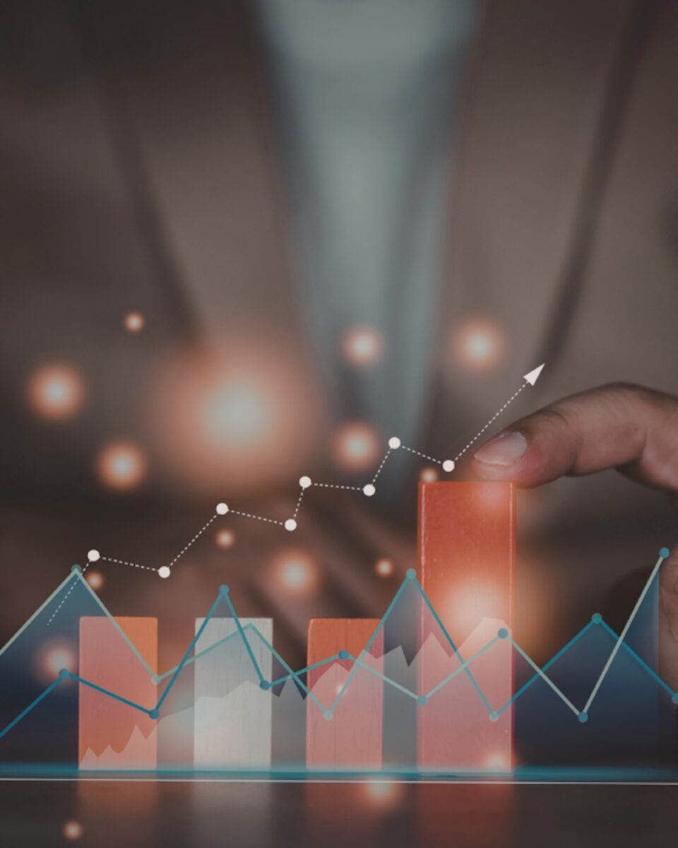 A hand pointing to a rising growth chart representing the expanding home improvement market.